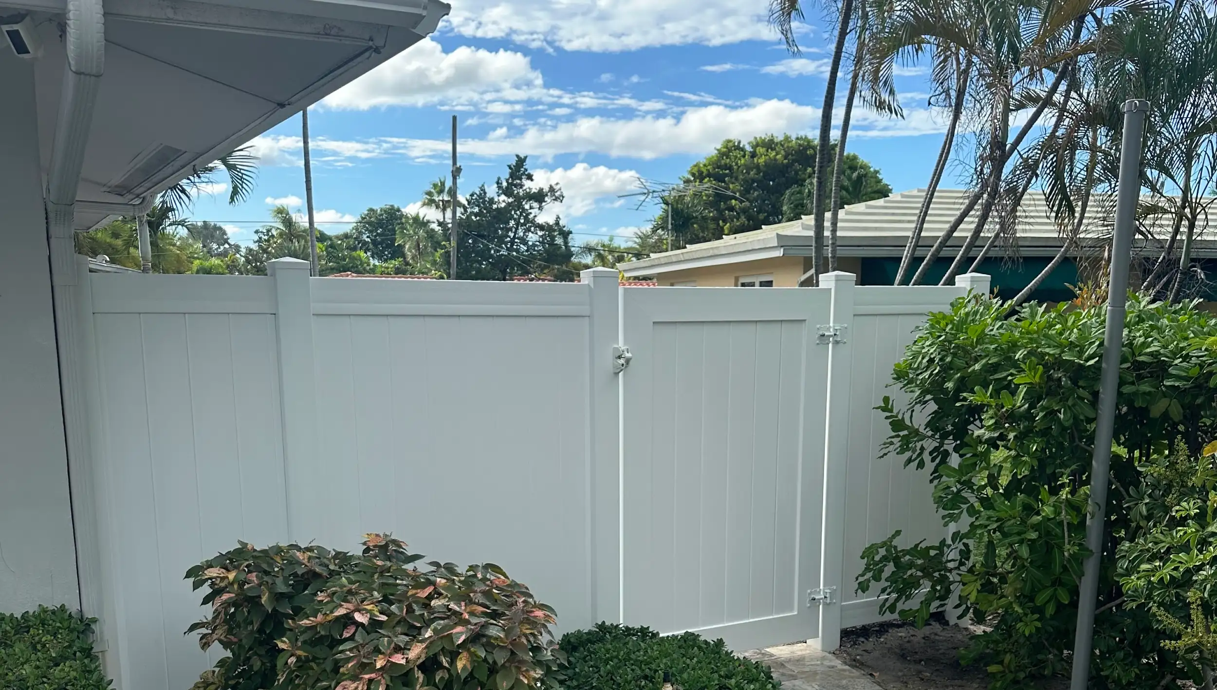 Completed outdoor living transformation featuring a white vinyl privacy fence by Delaurentiis Construction in Fort Lauderdale, FL.