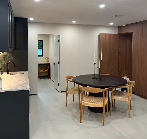Contemporary dining room and kitchen remodel featuring minimalist furniture and custom wood cabinetry.