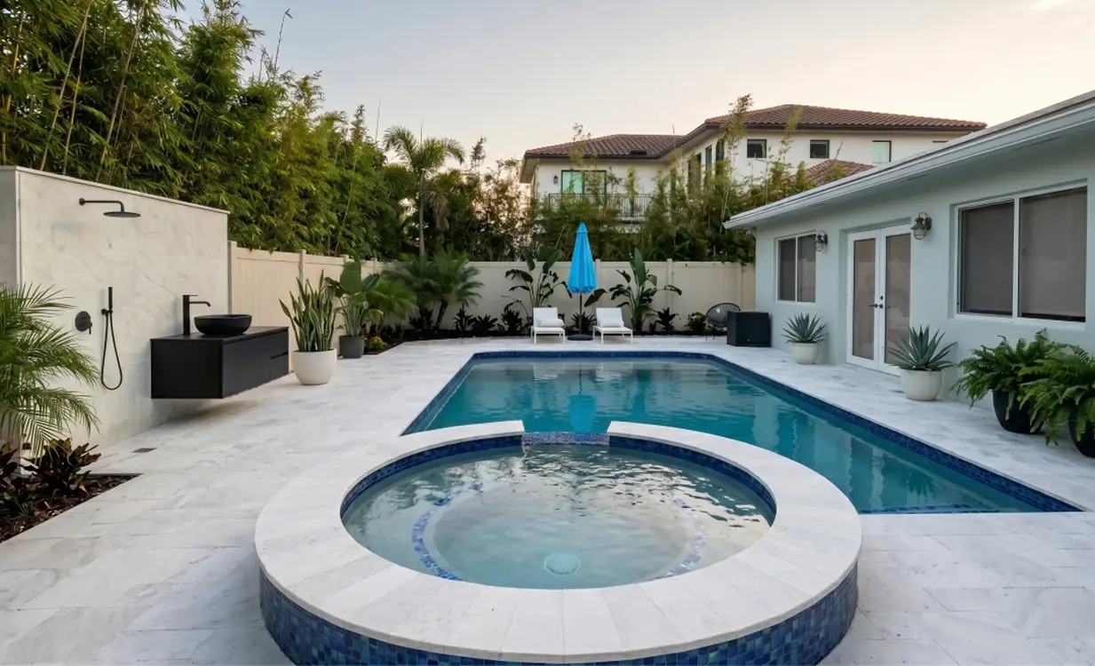 Luxury outdoor living renovations featuring a custom pool, integrated spa, and outdoor shower by Delaurentiis Construction.